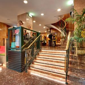 a set of stairs in a building with people at Hotel Hernán Cortés in Gijón