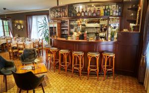a bar with stools and a man standing behind it at DC Sleep & Go Brussels West in Brussels