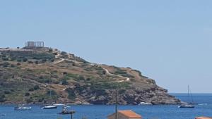 a small island in the water with boats on it at MOTEL KATERINA in Keratea