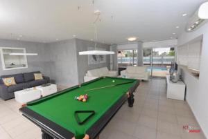 a living room with a pool table in it at Villa with heated pool and Jacuzzi Sea View 300m Front of the Beach in Eilat