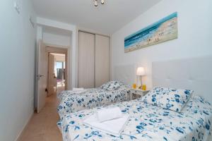 a bedroom with two beds with blue and white sheets at Villa Blue Horizon in Playa Blanca +31 photos