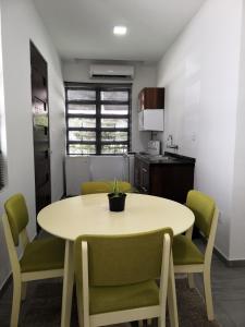 a kitchen with a table and chairs in a room at Bij BRAKKE in Paramaribo