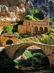 an old building on the side of a mountain at Lunair Ciudad de Medina in Medina de Pomar
