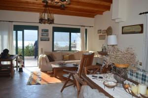 a living room with a couch and a table at Where the Mountains meet the Sea in Aigosthena