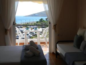 a bedroom with a bed and a view of the ocean at Villa Kostandin in Qeparo +40 photos