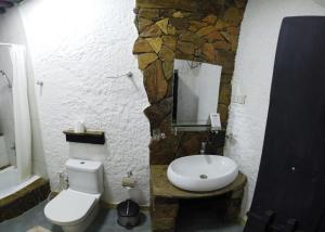 a bathroom with a white toilet and a sink at SAMA Wakan Heritage Homes in Fanjah
