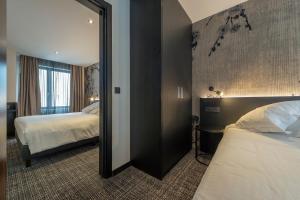 Postel nebo postele na pokoji v ubytování Hotel Monarc
