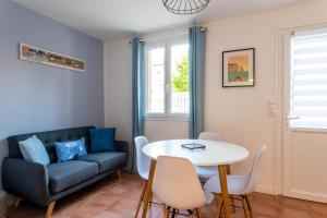 a living room with a couch and a table at La lisette in Étretat