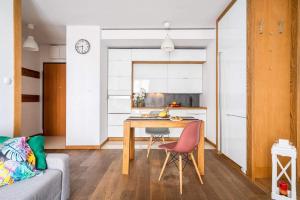 a kitchen and living room with a table and a couch at Art Apart Market Square Wrocław in Wrocław +53 photos