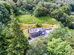 an aerial view of a house in the middle of a forest at Hilltop Cottage/ Penrhiw in Maentwrog