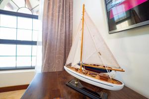 a model boat sitting on a table next to a window at Expectacular Penthouse frente al Mar con Jacuzzi in Jacó