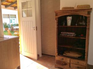 a kitchen with a wooden book shelf in a room at A Quinta da Estrelinha in Quinta de Cavaleiros