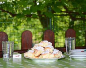 a plate of donuts sitting on a table at Guesthouse Vila Natalija in Gornja Trepča
