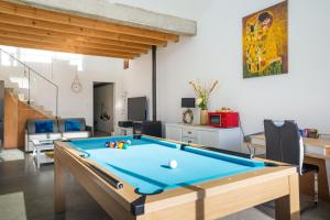 a living room with a pool table at Maison piscine centre ville La Tranche-sur-Mer in La Tranche-sur-Mer