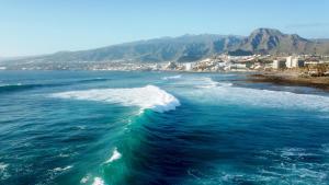 an aerial view of a wave in the ocean at 100 meters from the ocean in Callao Salvaje