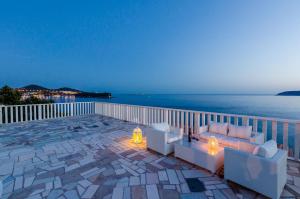 a patio with a view of the ocean at night at Stone Apartments in Dubrovnik