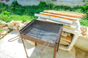 a bench sitting next to a pile of wood at Holiday HomeToni in Savar