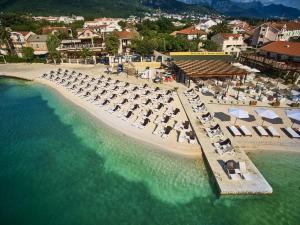 an aerial view of a beach with chairs and umbrellas at Waikiki Apartments in Tivat