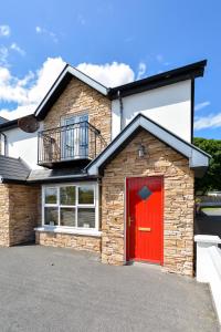 a brick house with a red door at 3 MAIN STREET DOWNINGS in Downings