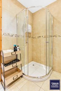a shower with a glass enclosure in a bathroom at 3 MAIN STREET DOWNINGS in Downings