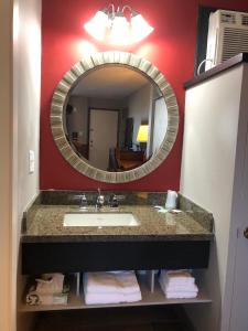 a bathroom with a sink and a mirror at Viking Motel in Lindsborg
