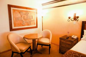 Postel nebo postele na pokoji v ubytování Business Hotel & Suites María Bonita