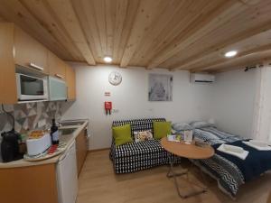 a living room with a couch and a table in a room at Tipico Romantico I in Setúbal +12 photos