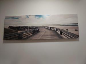 a painting of a boardwalk over the water at Tipico Romantico I in Setúbal