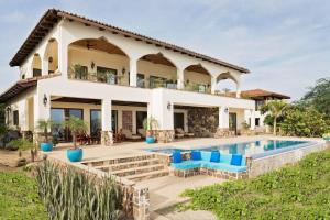 a villa with a swimming pool and a house at Fort Walker (Beachfront House) in Rivas