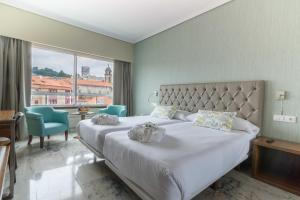 Кровать или кровати в номере Hotel Bahía de Vigo