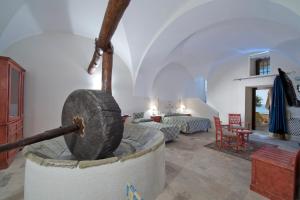 a living room with a fireplace in the middle of a room at Villa Il Frantoio and Lilmar in Praiano