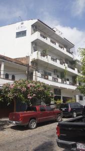 a red truck parked in front of a building at Casa del Parque Vallarta in Puerto Vallarta
