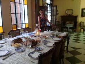 a woman standing in front of a table with food on it at TSEliot Bed&Breakfast in Banfield