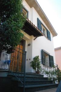 a white house with stairs and a door at Fabiola B & B in Marino