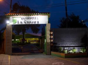 a sign for a restaurant at night at Ecohotel La Casona Pereira in Pereira