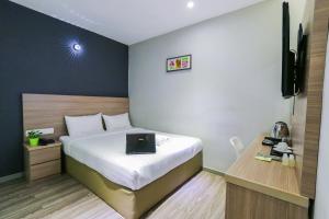 Postel nebo postele na pokoji v ubytování Hotel 99 SS2 Petaling Jaya
