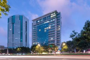 two tall buildings in a city at night at Spring Time Hotel in Guangzhou