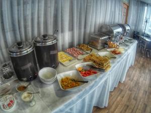 a table with a buffet of food on it at Geyzer Hotel in Petropavlovsk-Kamchatskiy