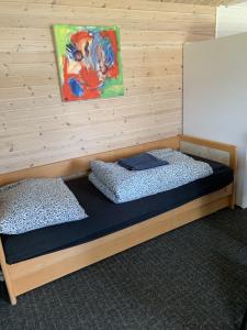 a bedroom with two beds and a painting on the wall at Amazing Herlev in Herlev