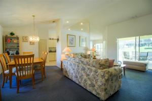 a living room with a couch and a table at Villa Lovie - Family & Golf vacations in Inverness