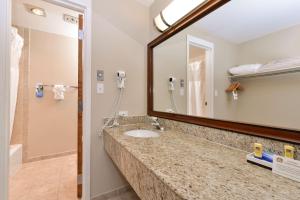 a bathroom with a sink and a mirror at Best Western University Inn in Fort Collins
