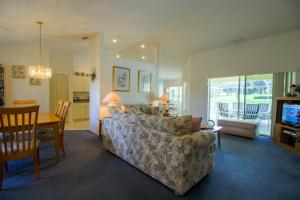 a living room with a couch and a dining room at Villa Lovie - Family & Golf vacations in Inverness