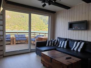 a living room with a blue couch and a table at Bazyl Apartment in Folkedal