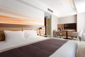a hotel room with a bed and a desk at Haneda Excel Hotel Tokyu Haneda Airport Terminal 2 in Tokyo