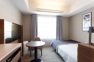 a hotel room with two beds and a table at Haneda Excel Hotel Tokyu in Tokyo