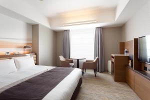 a hotel room with a bed and a television at Haneda Excel Hotel Tokyu Haneda Airport Terminal 2 in Tokyo