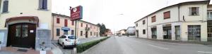 a car parked on the side of a street next to buildings at Albergo Airone in Ostellato