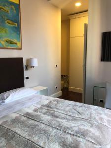 a hotel room with a bed and a desk at Guest House Cavour 278 in Rome