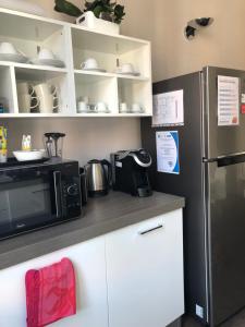 a kitchen with a refrigerator and a microwave at Guest House Cavour 278 in Rome