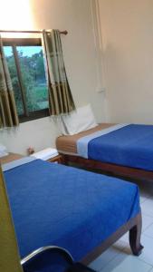 En eller flere senge i et værelse på Benjamat Resort